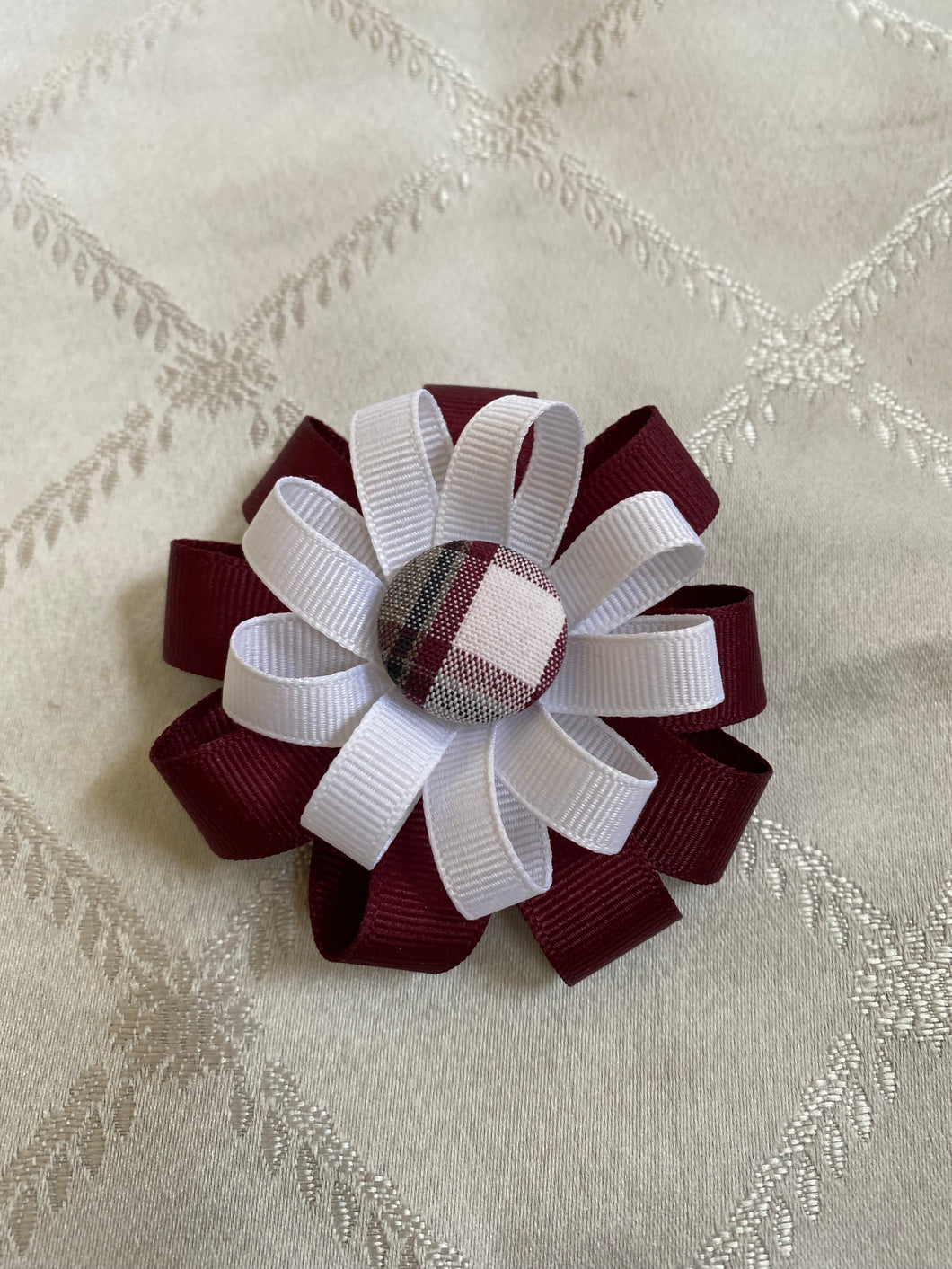 2 layered ribbon bow w/plaid button on a barette